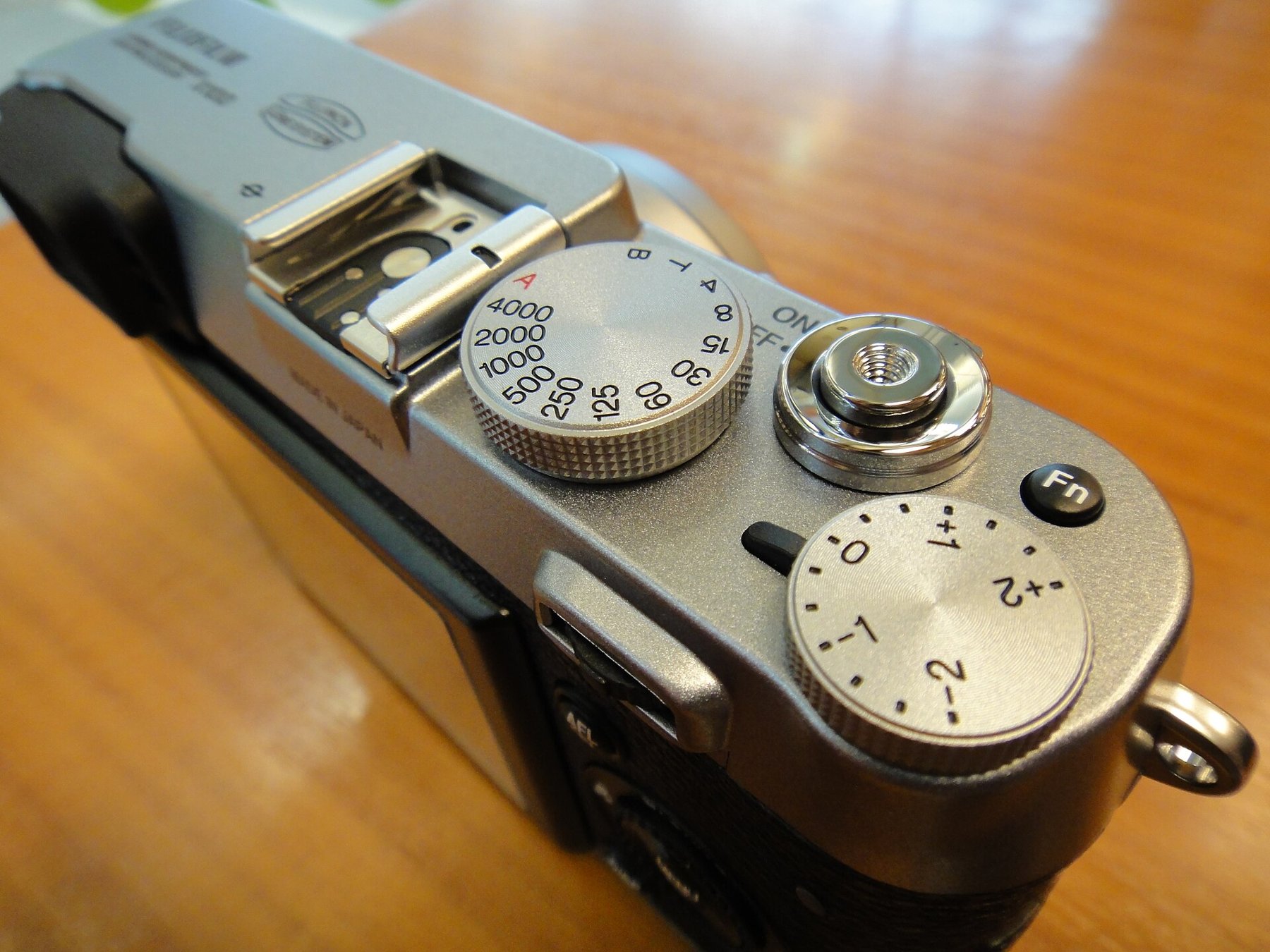 A camera exposure compensation dial with plus and minus values.