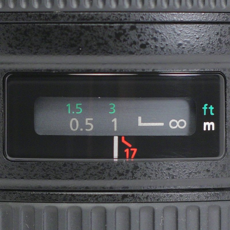 Lens distance scale with close-focus and infinity markings.