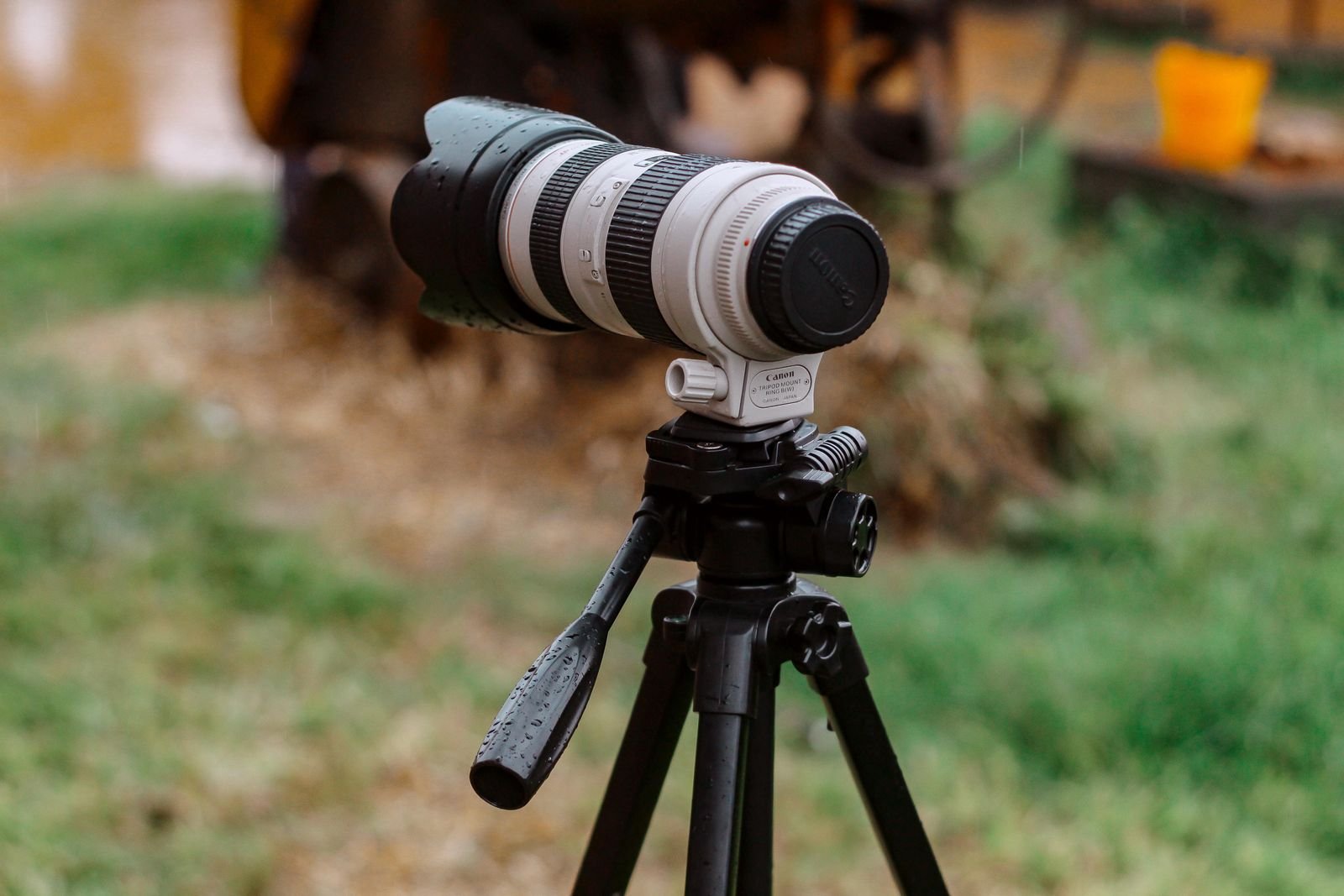 Camera with a long lens mounted on a tripod.
