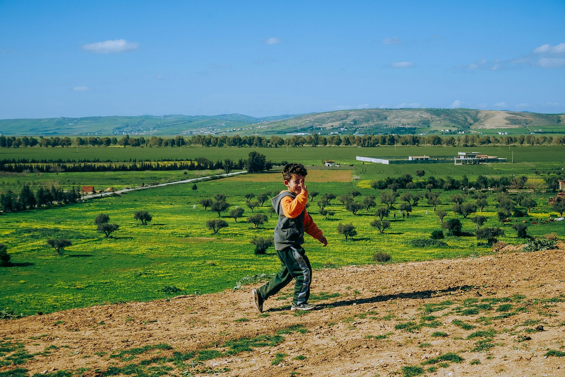 A child running on a hillside.