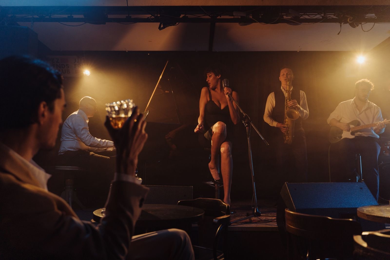 Musicians on a dimly lit stage.