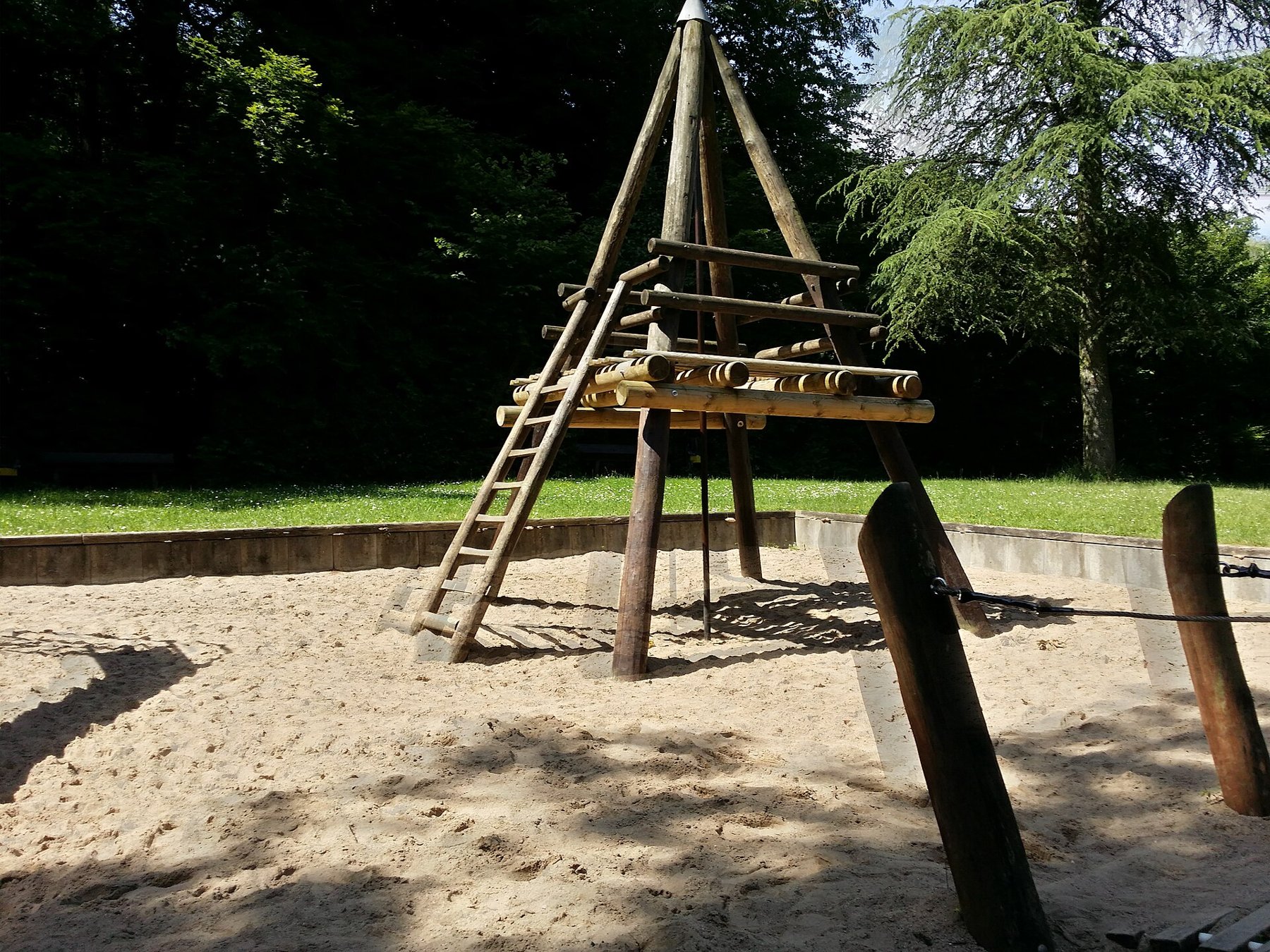 HDR photograph of a playground with a small ghosted outline at the moving swing subject.