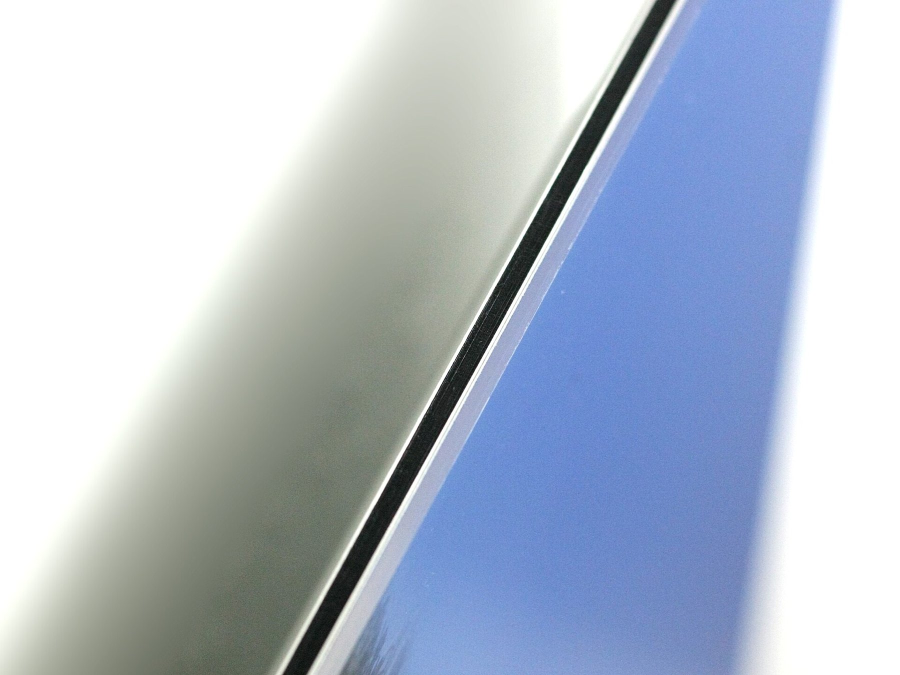 A photographic print mounted behind acrylic glass on a backing panel.
