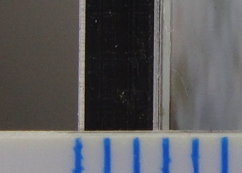 Close-up of the layers of a photograph mounted on aluminium composite panel.